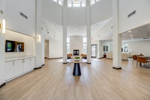 a large living room with a fireplace and a table